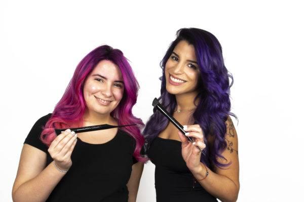 Women posing with hair color brush
